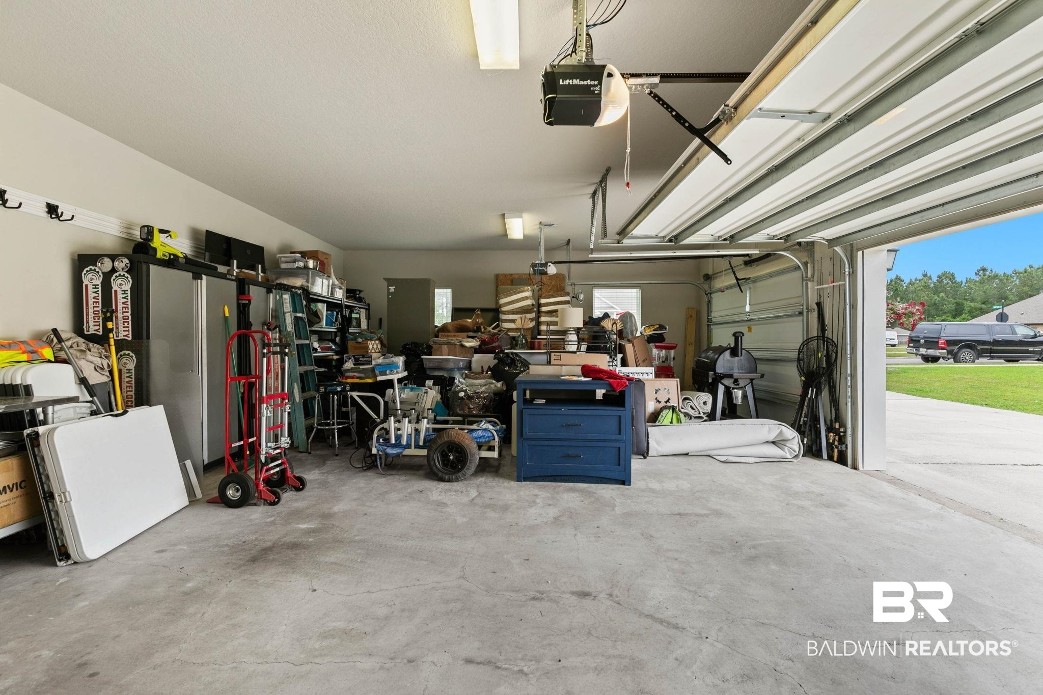 31187 Spoonbill Road Daphne, AL 36527 - Photo 83 of 85 Attached two-car garage with a concrete floor and an automatic garage door opener