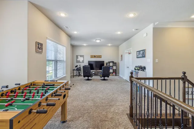 a living room with furniture and gym equipment