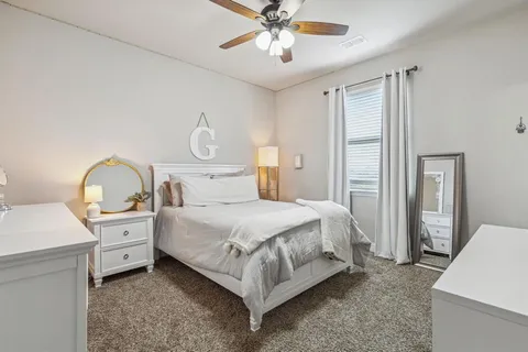 a bedroom with a bed and a chandelier