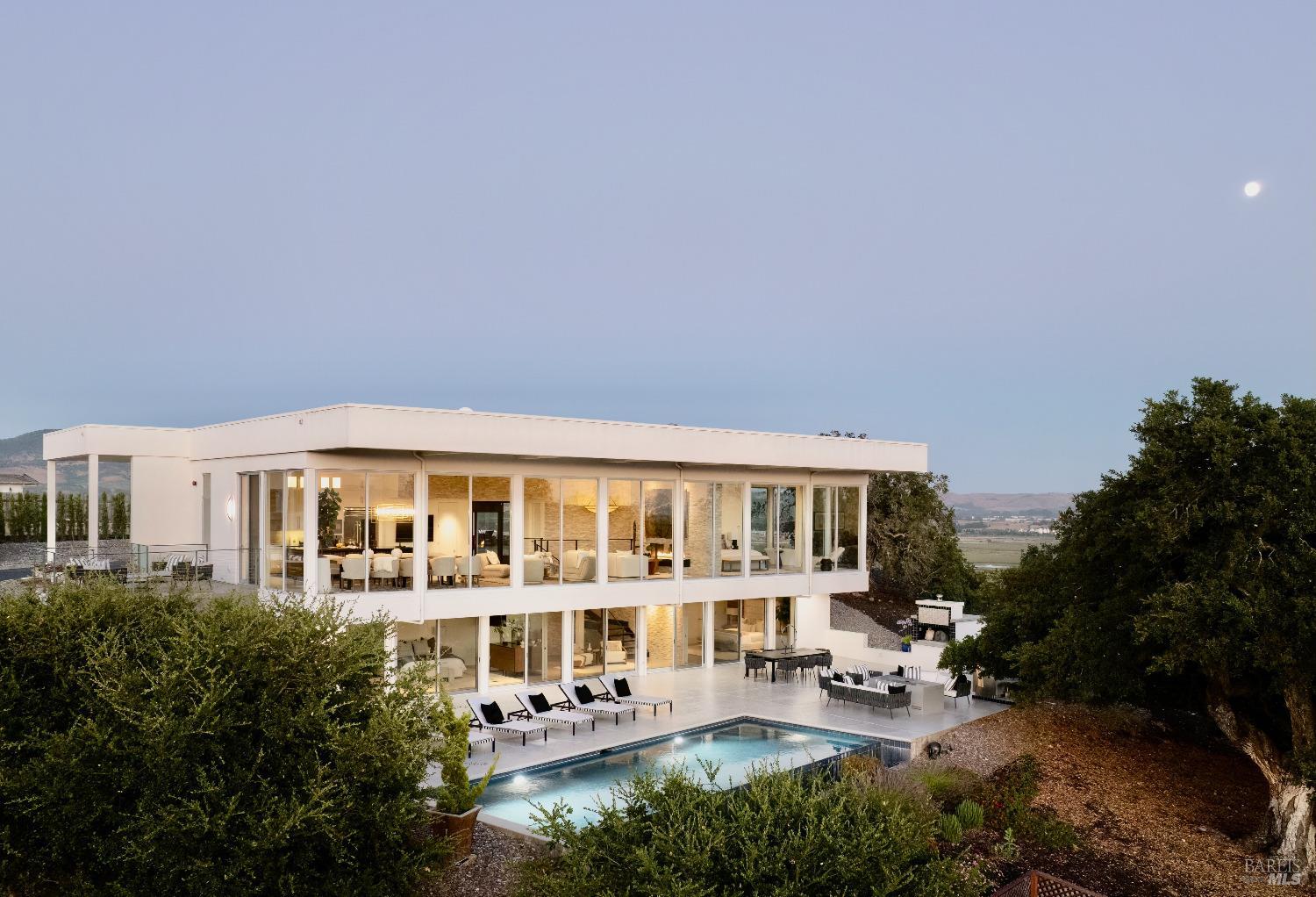 a view of a building with a garden and sitting area