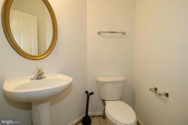 a bathroom with a sink a mirror and a toilet