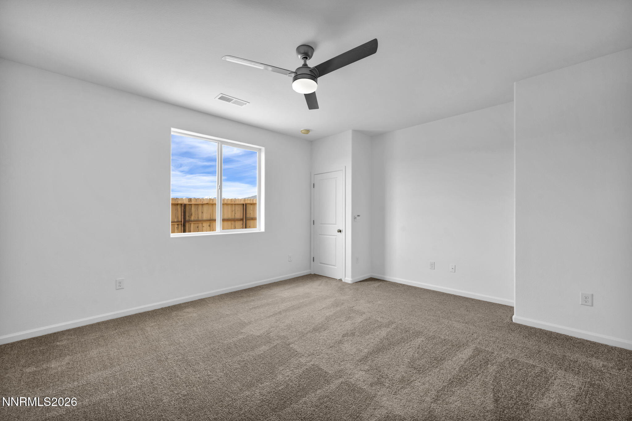 6676 Morgan Mill Road, Unit HOMESITE 14 Carson City, NV 89701 - Photo 14 of 24 an empty room with ceiling fan and windows