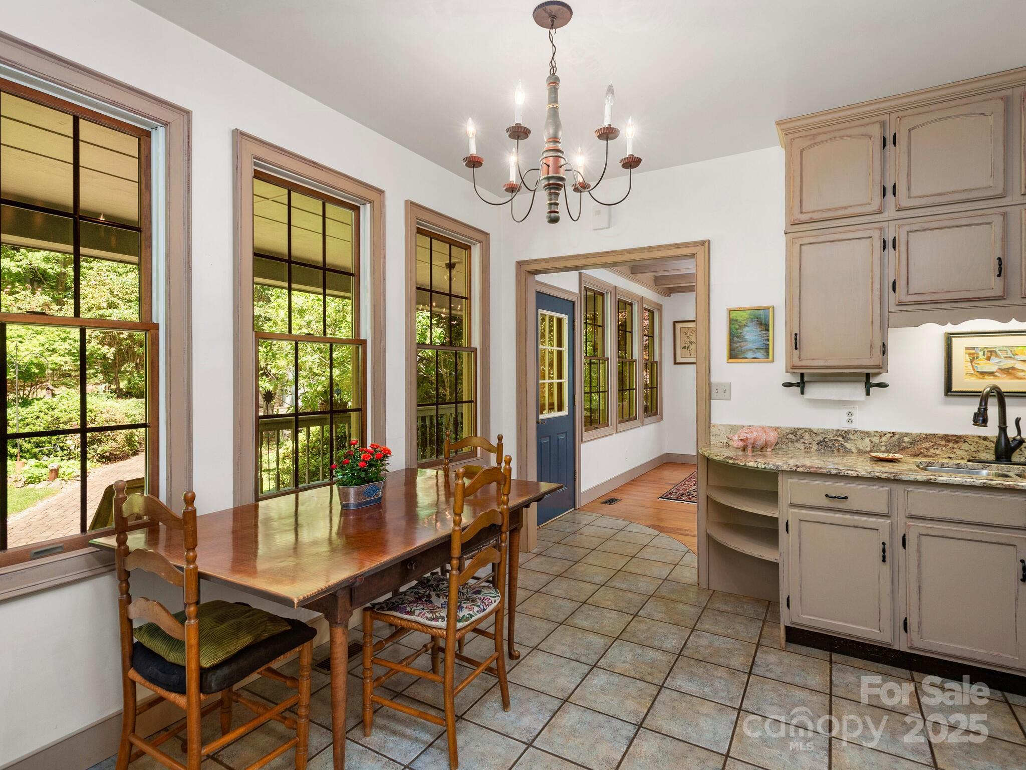 116 Sams Branch Road Candler, NC 28715 - Photo 13 of 47 a view of a dining room with furniture a chandelier and window