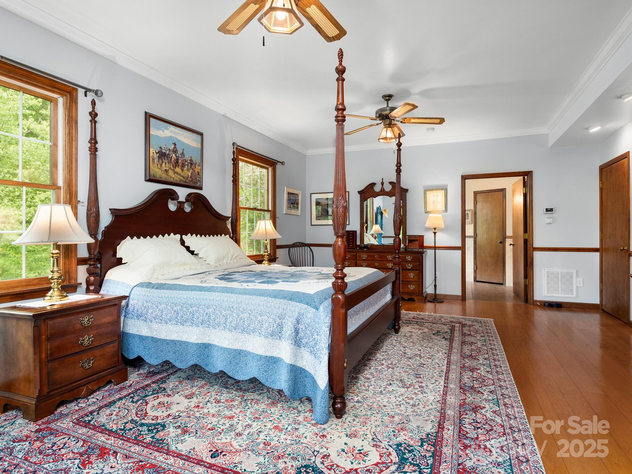 116 Sams Branch Road Candler, NC 28715 - Photo 17 of 47 a bed room with a bed lamp closet and large window