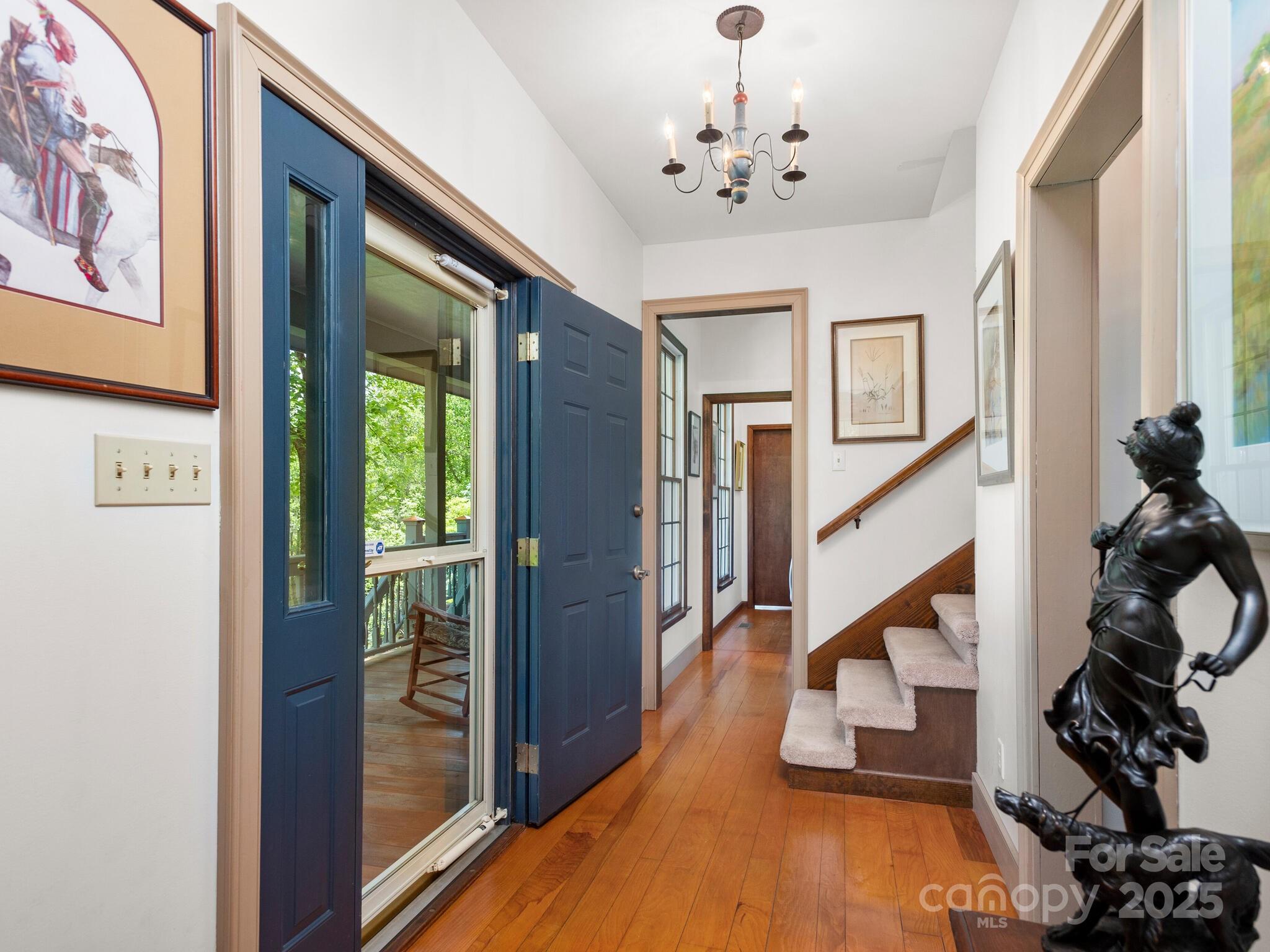 116 Sams Branch Road Candler, NC 28715 - Photo 21 of 47 a view of a hallway with wooden floor and staircase