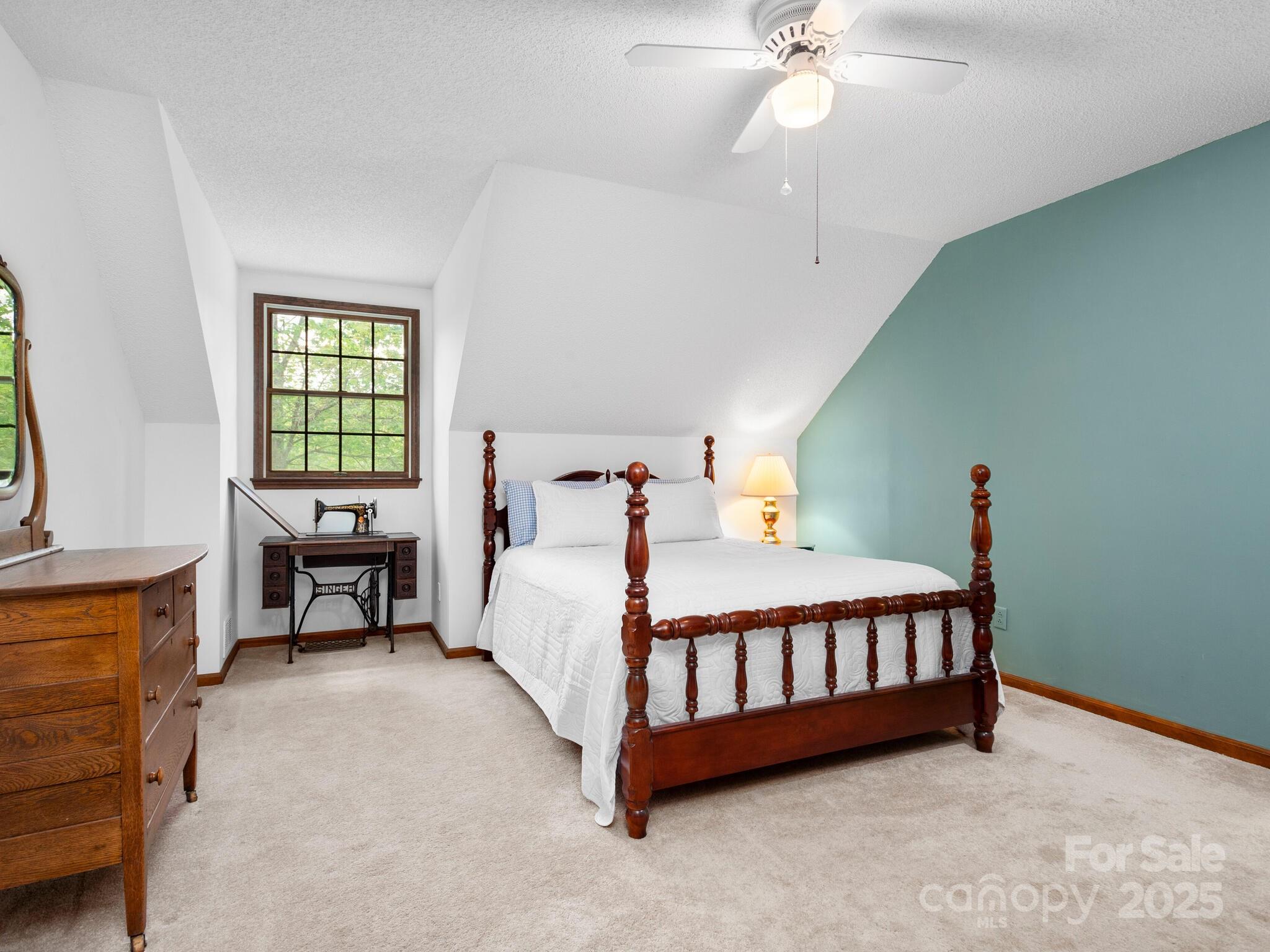 116 Sams Branch Road Candler, NC 28715 - Photo 22 of 47 a bed sitting in a bedroom next to a window