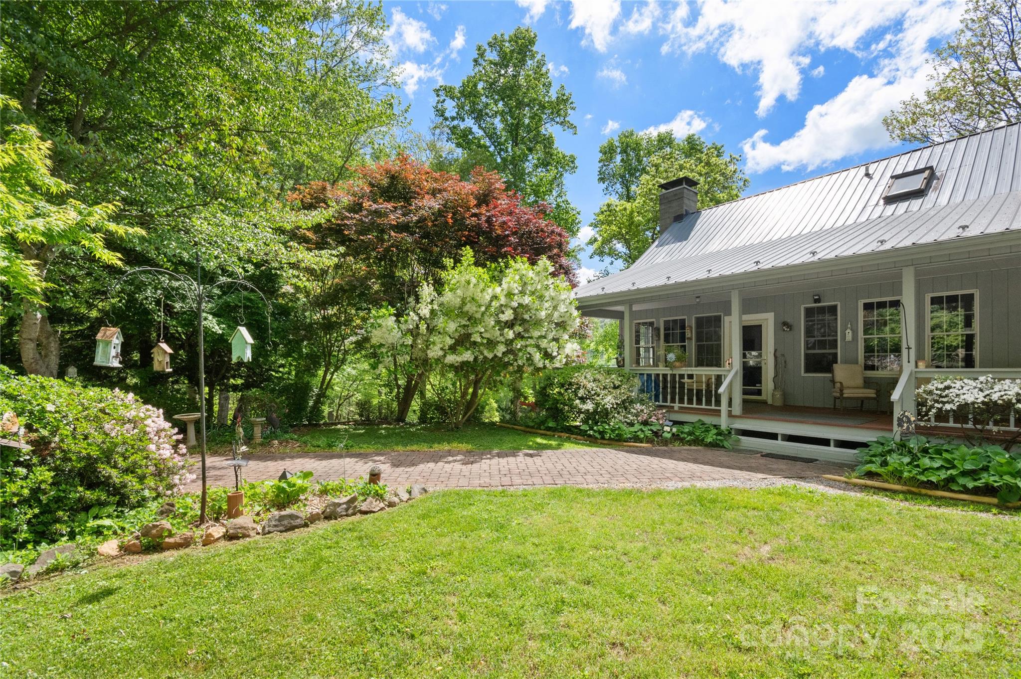116 Sams Branch Road Candler, NC 28715 - Photo 3 of 47 a view of a house with backyard sitting area and garden