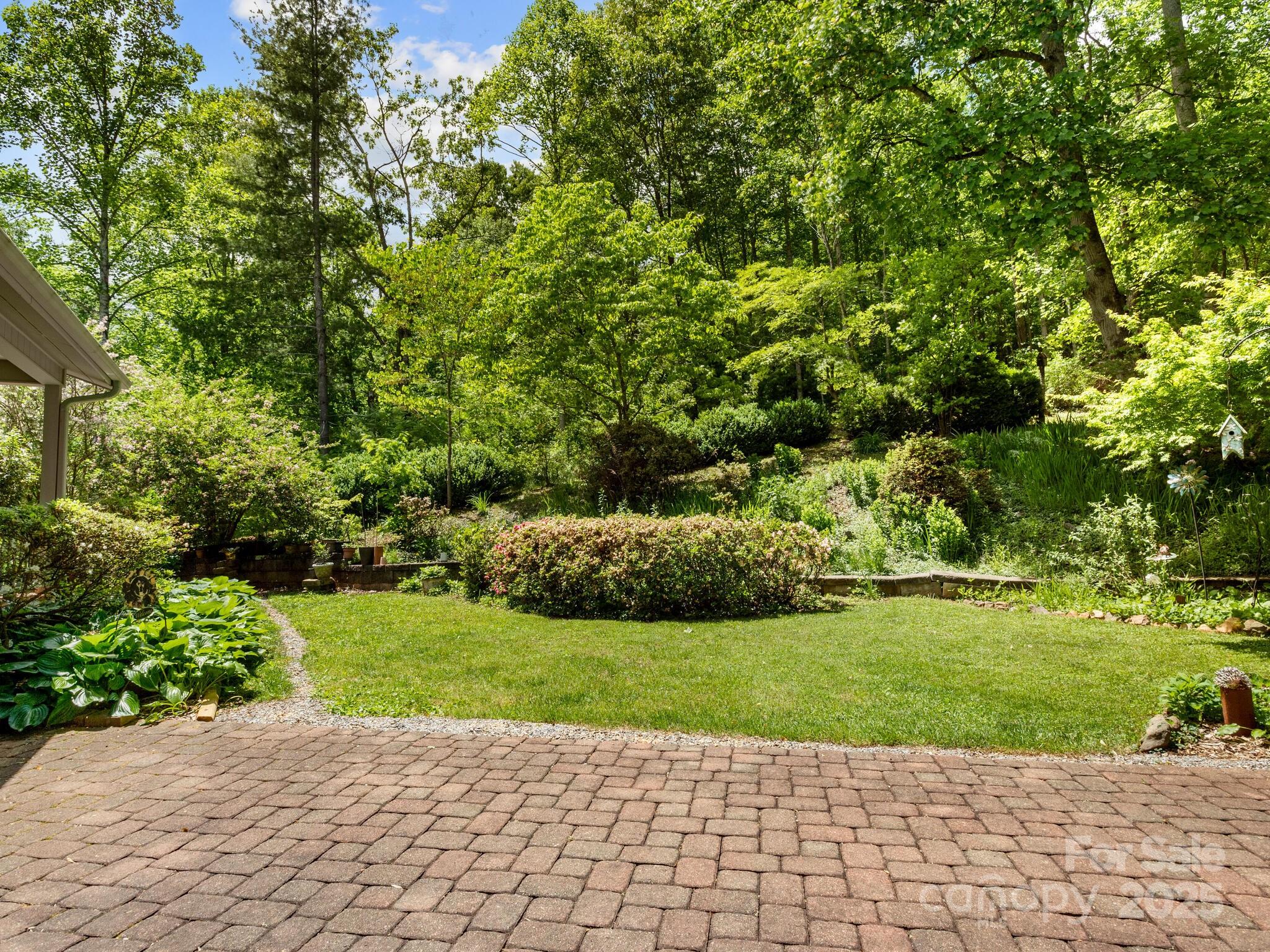 116 Sams Branch Road Candler, NC 28715 - Photo 36 of 47 a view of a garden with a bench