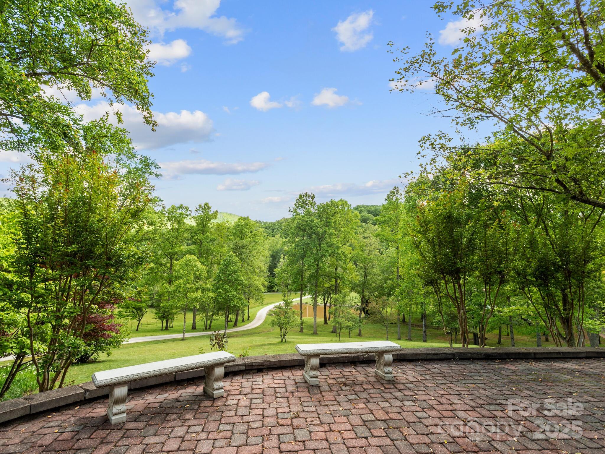 116 Sams Branch Road Candler, NC 28715 - Photo 37 of 47 a view of a yard with plants and a bench