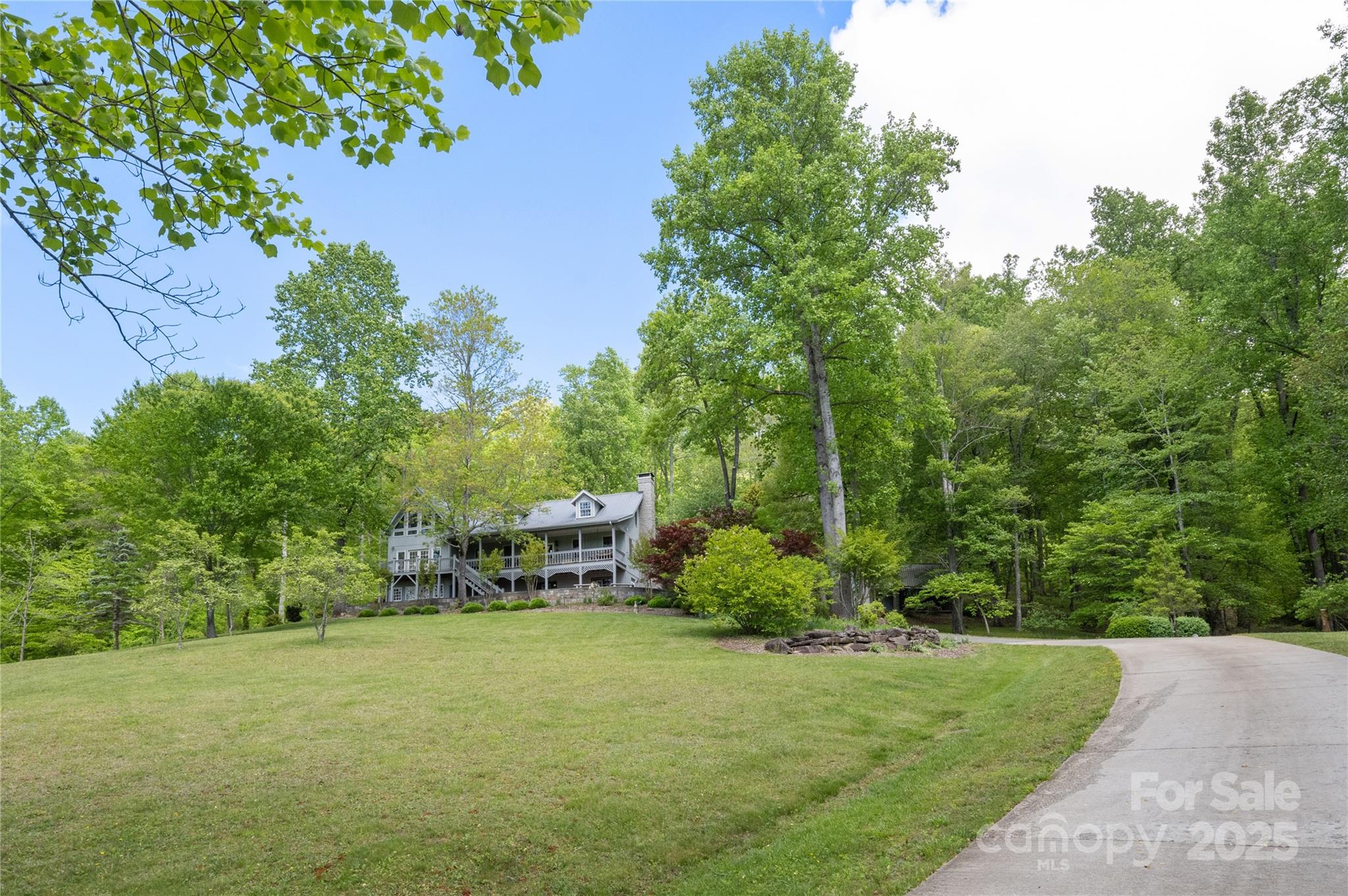116 Sams Branch Road Candler, NC 28715 - Photo 47 of 47 a view of a backyard with table and chairs plants and large trees