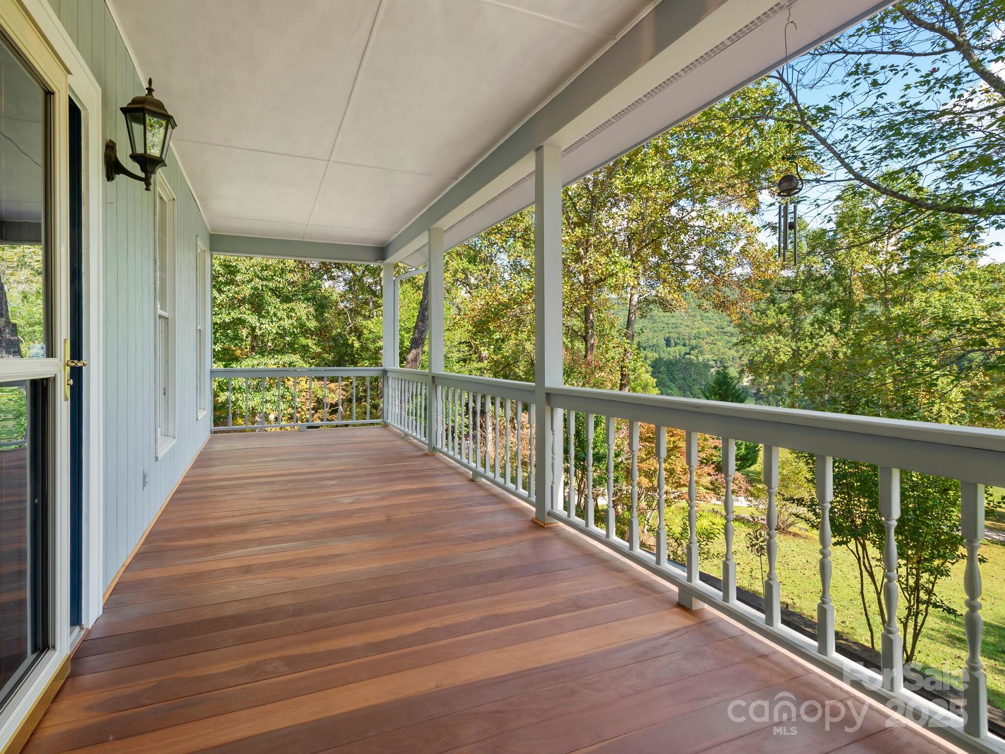 116 Sams Branch Road Candler, NC 28715 - Photo 6 of 47 a view of a balcony with wooden floor