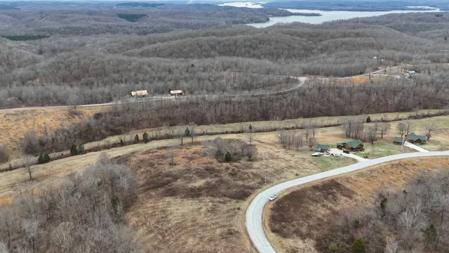 a view of a dry yard with wooden fence