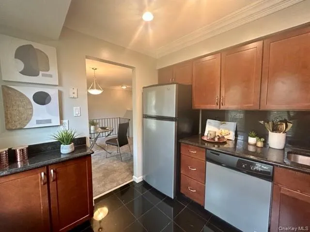 a kitchen with refrigerator and cabinets