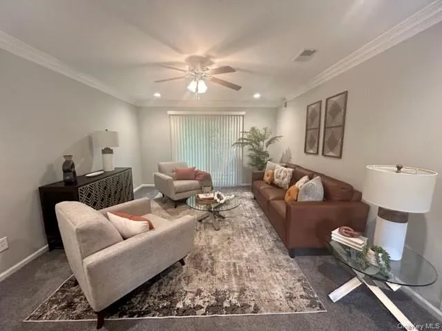 a living room with furniture and a chandelier