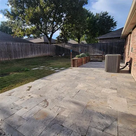 a view of backyard with seating and green space