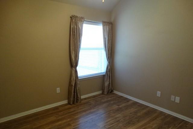 15785 Scenic Road Frisco, TX 75035 - Photo 16 of 21 an empty room with wooden floor and window
