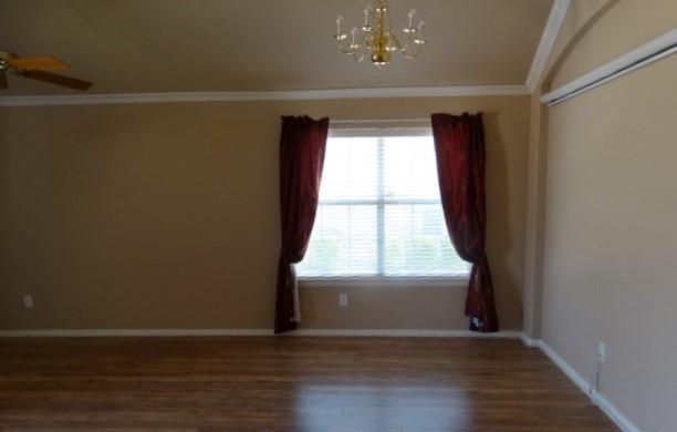 15785 Scenic Road Frisco, TX 75035 - Photo 18 of 21 a view of an empty room with wooden floor and a window
