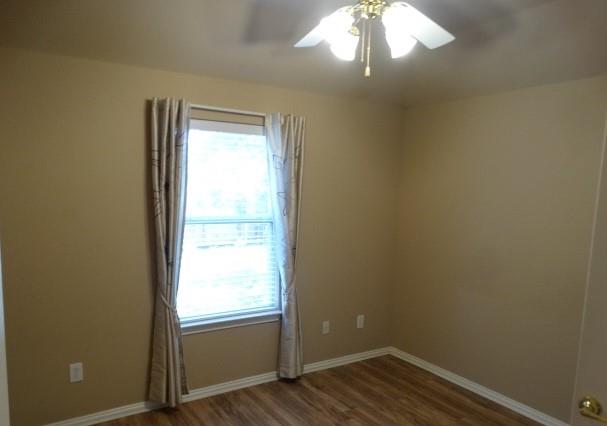 15785 Scenic Road Frisco, TX 75035 - Photo 19 of 21 an empty room with wooden floor windows and entrance