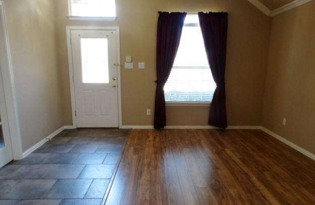 15785 Scenic Road Frisco, TX 75035 - Photo 3 of 21 an empty room with wooden floor and windows