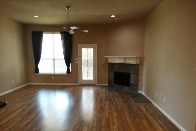 15785 Scenic Road Frisco, TX 75035 - Photo 5 of 21 an empty room with wooden floor fireplace and windows