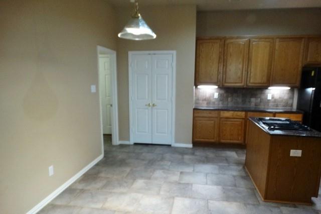 15785 Scenic Road Frisco, TX 75035 - Photo 6 of 21 a kitchen with a stove a sink and cabinets