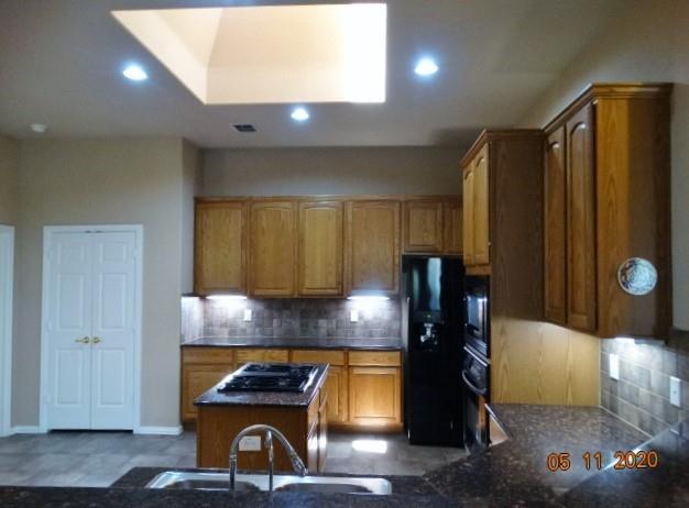 15785 Scenic Road Frisco, TX 75035 - Photo 7 of 21 a kitchen with granite countertop a refrigerator and a stove