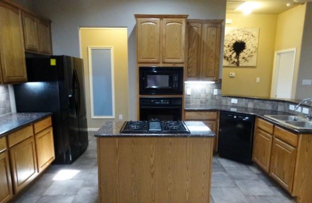 15785 Scenic Road Frisco, TX 75035 - Photo 8 of 21 a kitchen with stainless steel appliances granite countertop a stove a refrigerator and a microwave