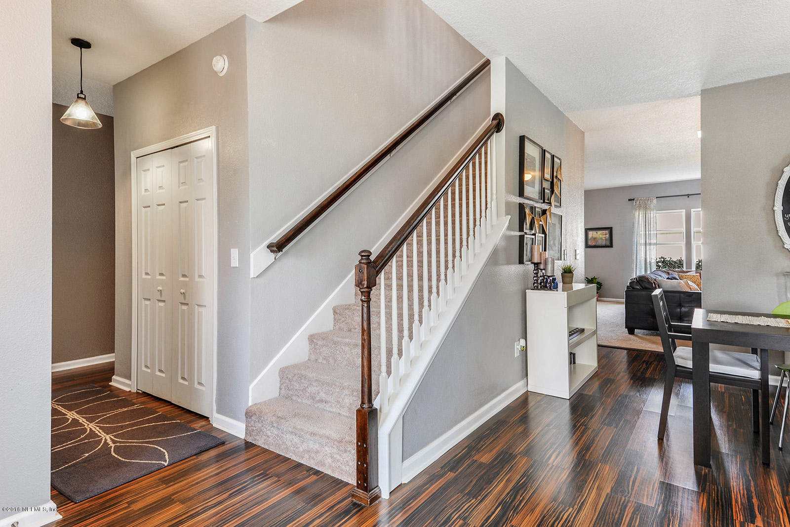 16349 Tisons Bluff Road Jacksonville, FL 32218 - Photo 8 of 31 a view of a hallway view with wooden floor and staircase