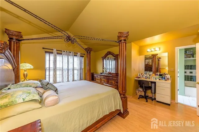 a bedroom with a bed and large windows