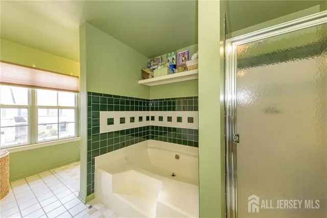 a bathroom with a bathtub and a shower