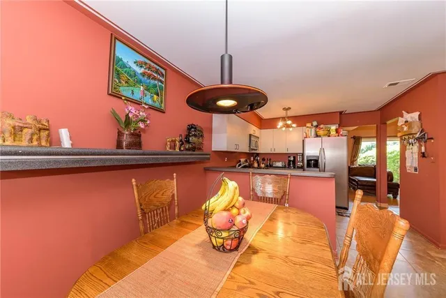 a kitchen with stainless steel appliances granite countertop a sink and wooden floor