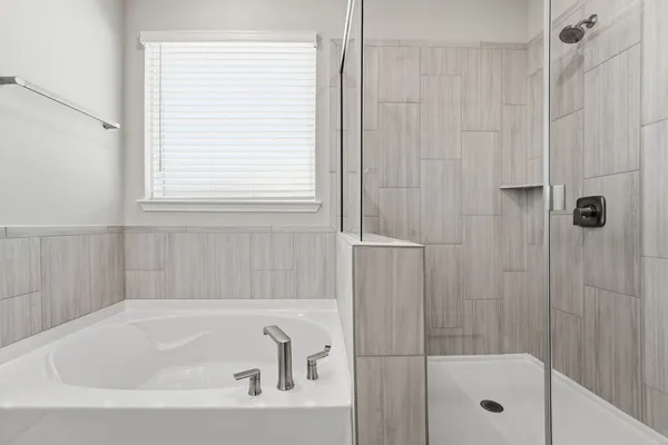 a white bath tub sitting next to a shower
