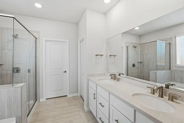 a spacious bathroom with double vanity sink and a mirror