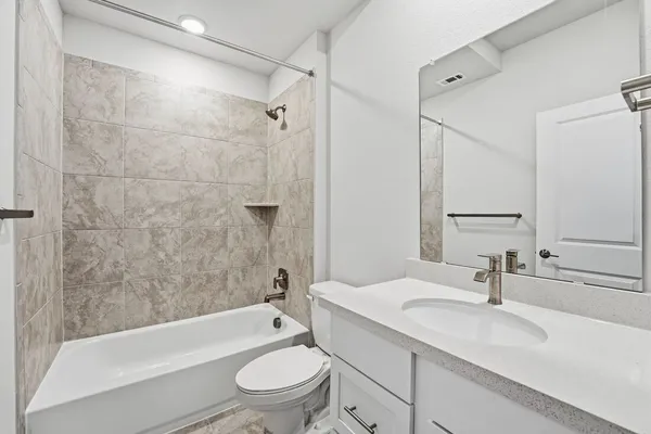 a bathroom with a sink toilet a mirror and shower
