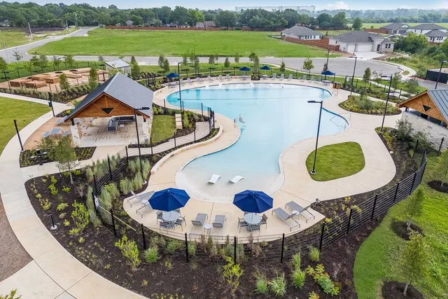 an aerial view of house with yard swimming pool and outdoor seating