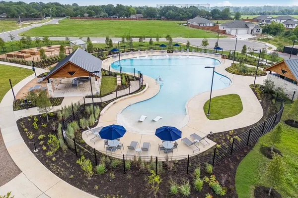 an aerial view of house with yard swimming pool and outdoor seating