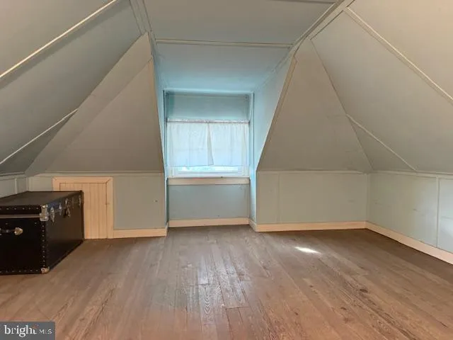 a room with wooden floor and a window