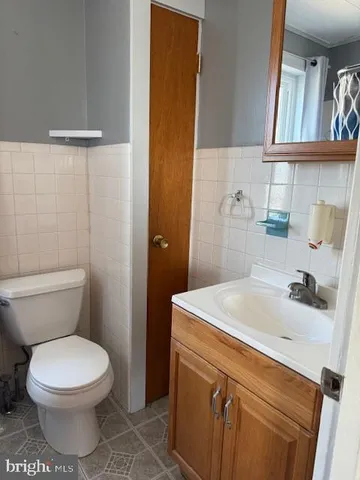 a bathroom with a sink a toilet and mirror