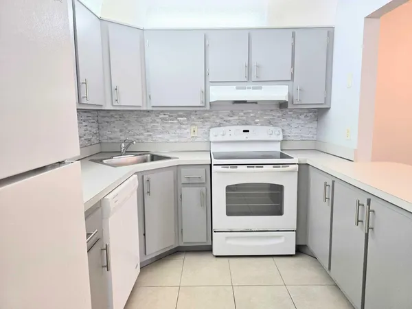 a white refrigerator freezer sitting inside of a kitchen