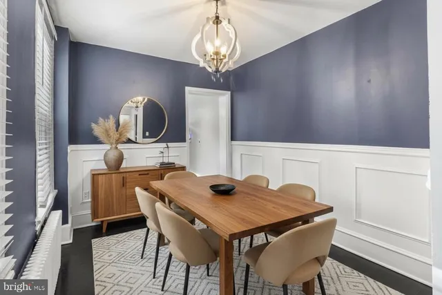 a view of a dining room with furniture and chandelier