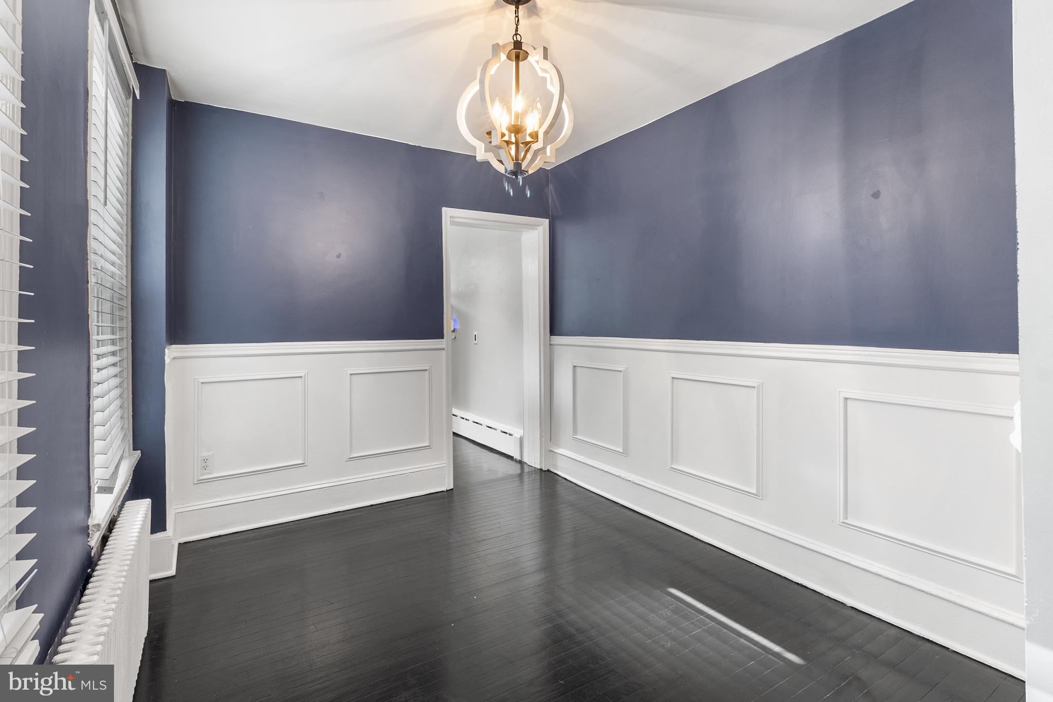 1204 West 8th Street Wilmington, DE 19806 - Photo 13 of 35 a view of an empty room with wooden floor and cabinet