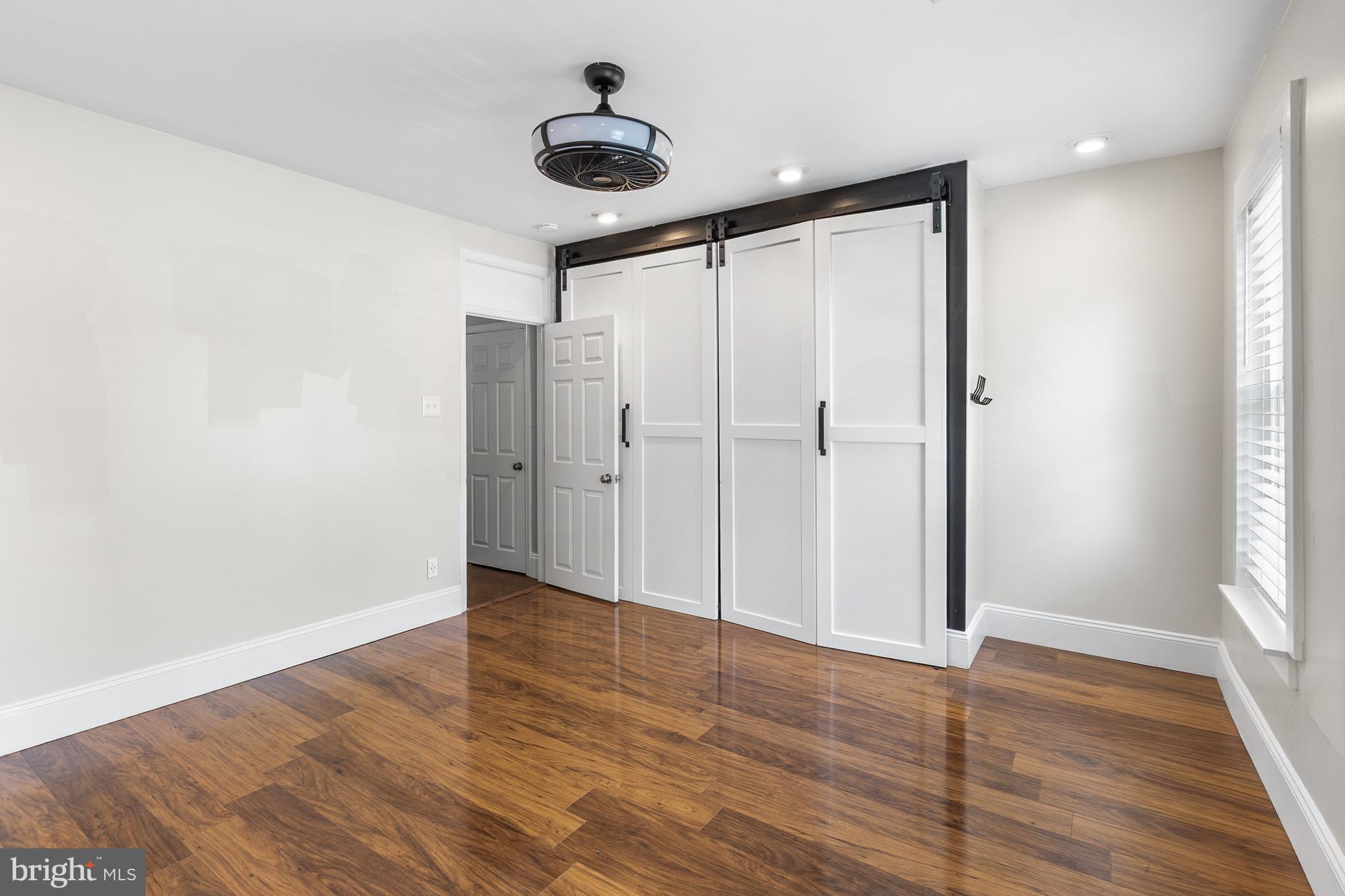 1204 West 8th Street Wilmington, DE 19806 - Photo 19 of 35 a view of an empty room with wooden floor and a window