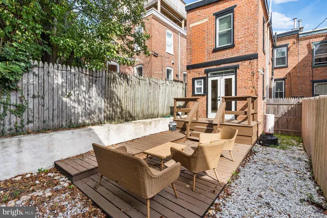 a backyard of a house with table and chairs