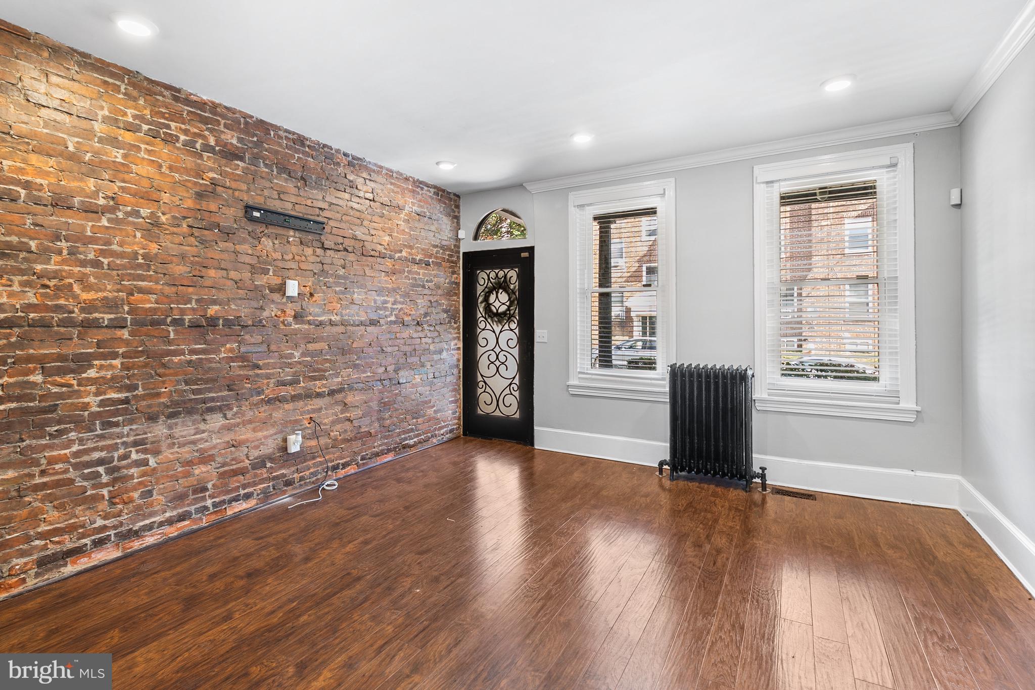 1204 West 8th Street Wilmington, DE 19806 - Photo 6 of 35 a view of an empty room with a window and wooden floor