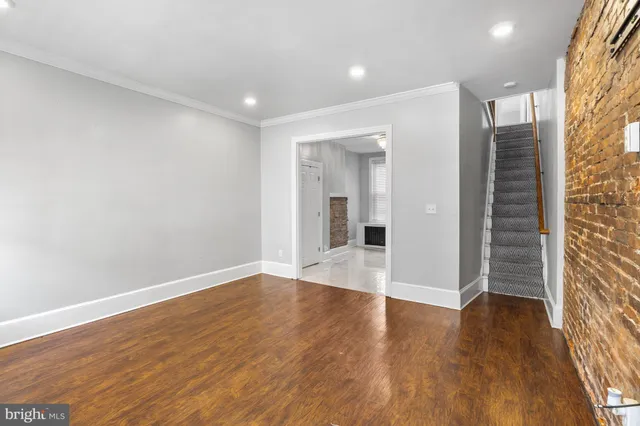 a view of a hallway with wooden floor