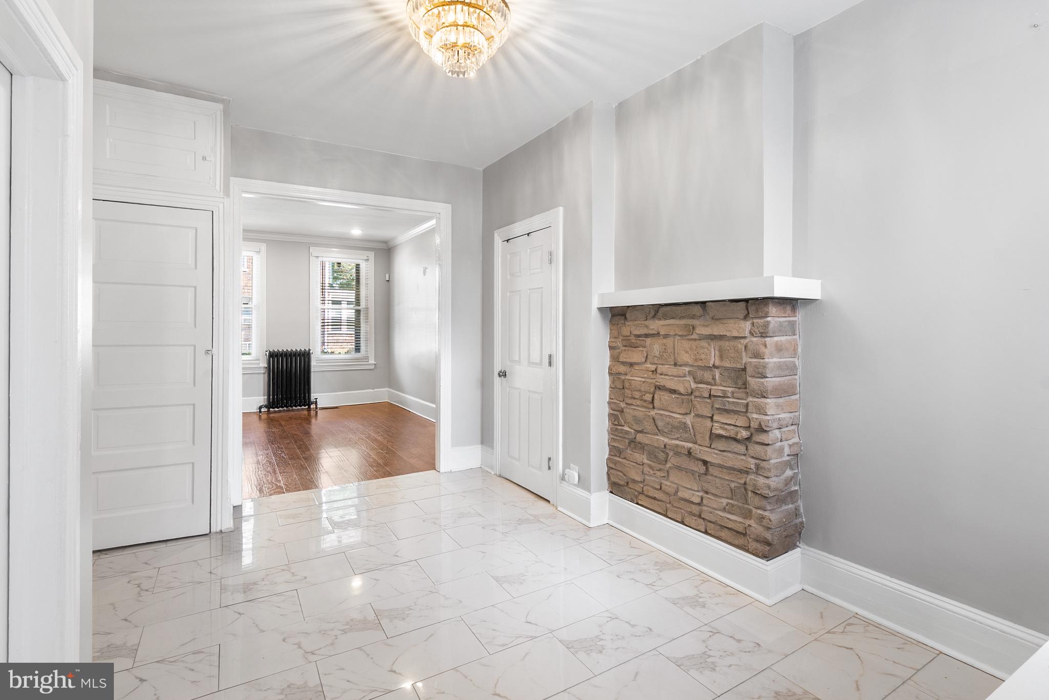 1204 West 8th Street Wilmington, DE 19806 - Photo 10 of 35 an empty room with kitchen view and natural light