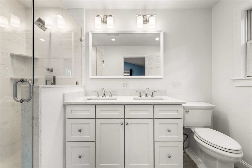 166 Hillcrest Road Needham, MA 02492 - Photo 17 of 36 a bathroom with a toilet sink vanity and mirror