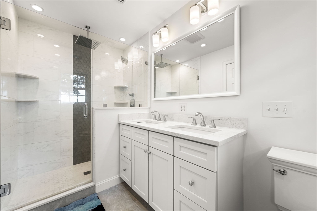 166 Hillcrest Road Needham, MA 02492 - Photo 18 of 36 a bathroom with a double vanity sink mirror and shower