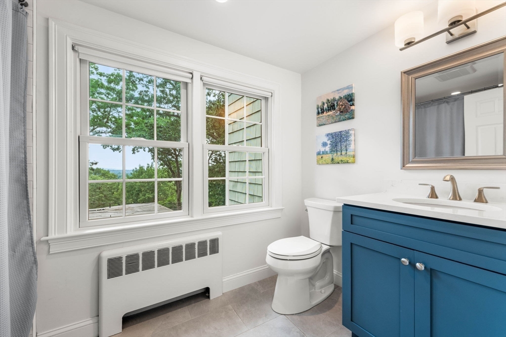 166 Hillcrest Road Needham, MA 02492 - Photo 24 of 36 a bathroom with a toilet sink a mirror and next to a window