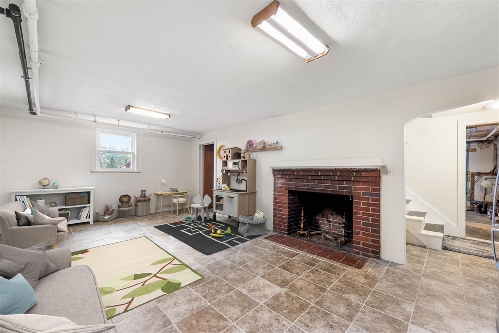 166 Hillcrest Road Needham, MA 02492 - Photo 25 of 36 a living room with furniture and a fireplace
